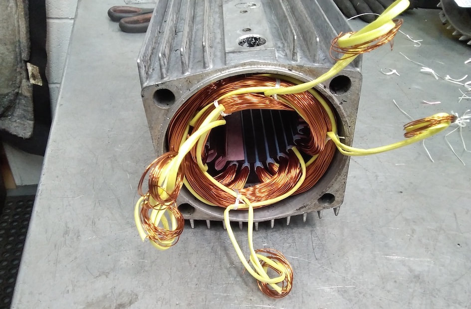 An electric motor from a glass-cutting saw which was repaired.