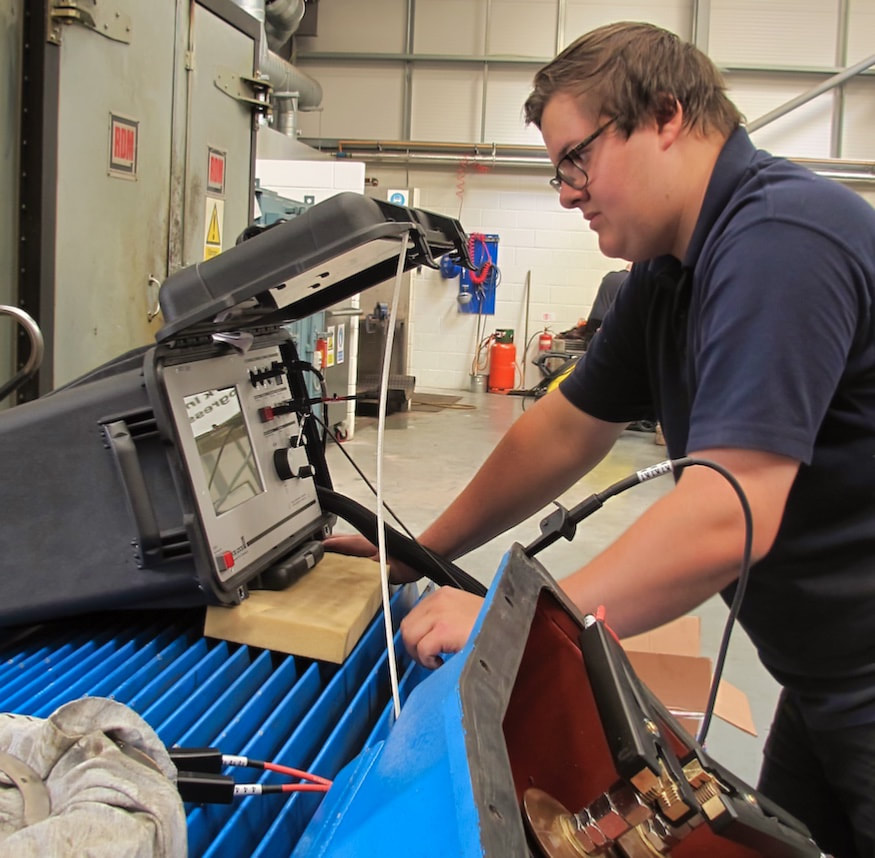 Apprentice Jason Kilner operates the portable surge tester in the Huddersfield service centre of Westin Drives.